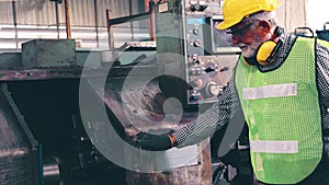 Senior factory worker teach how to use machine equipment in the factory workshop