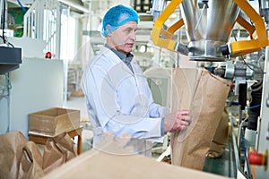 Senior Factory Worker Working at Packaging Line