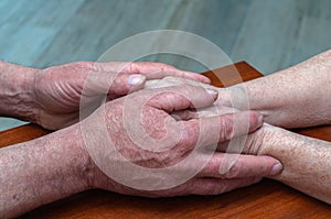 Senior family couple holding old hands, psychological support concept