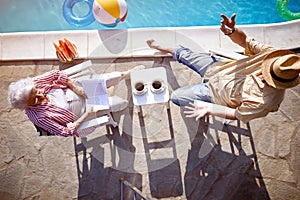 Senior family  enjoy on summer holiday near swimming pool.Top view