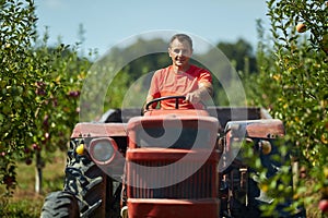 Senior farmer driving his tractor