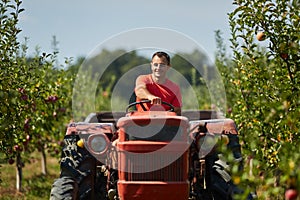 Senior farmer driving his tractor