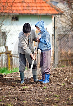 Senior farmer with grandson in the garden