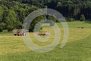 senior farmer haying wiht an old traktor