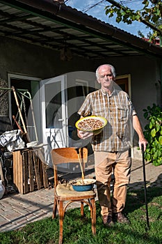 Senior farmer holding bowl of kidney beans