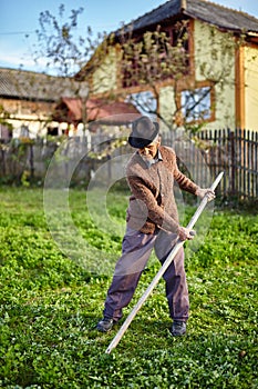 Senior farmer mowing the yard