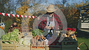 Senior farmer stands at the stall at farmers market