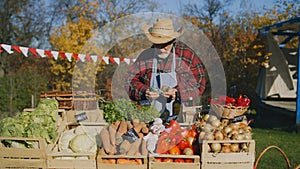 Senior farmer stands at the stall at farmers market
