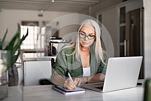 Senior fashionable woman working at home photo