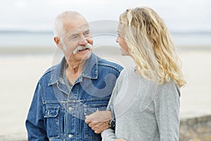 Senior father with adult daughter at sea