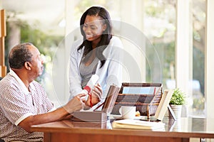 Senior Father Discussing Document With Adult Daughter