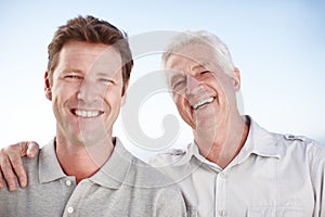 Senior father, man and hug for portrait with smile, outdoor and bonding on vacation with summer sky. Elderly dad, son