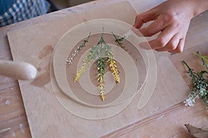 Senior female artisan creating handmade ceramics in pottery studio