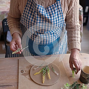 Senior female artisan creating handmade ceramics in pottery studio