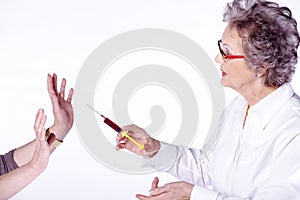 Senior female doctor injects patient