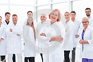 Senior female doctor standing in front of her colleagues.