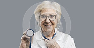 Senior female doctor using a stethoscope