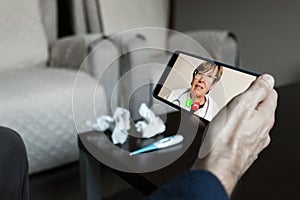 Senior female doctor videoconferencing with patient about coronavirus symptoms covid19 over video chat through mobile phone. Onl