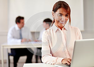 Senior female enterpreneur working with her laptop