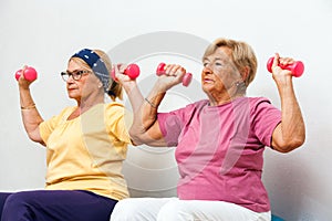Senior female fitness girls working out with weights. photo