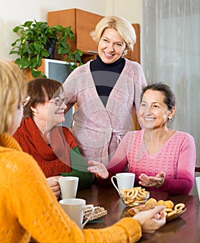 Senior female friends drinking coffee