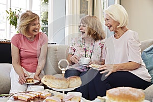 Senior Female Friends Enjoying Afternoon Tea At Home Together