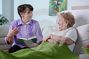 Senior female friends spending time together in nursing home