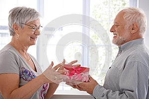 Senior female getting present from husband