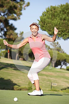 Senior Female Golfer On Golf Course