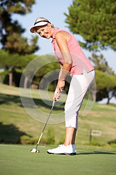 Senior Female Golfer On Golf Course