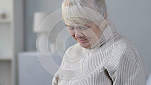 Senior female looking at brain x-ray and crying, suffering oncological disease