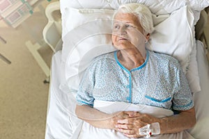 Senior female patient in hospital bed