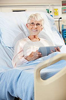 Senior Female Patient Relaxing In Hospital Bed