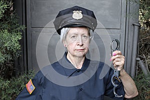Senior female police officer holding handcuffs