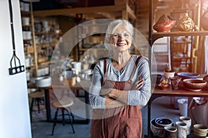 Senior female pottery artist in her art studio