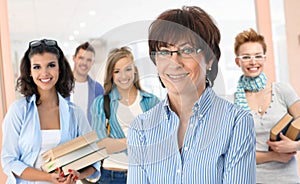 Senior female teacher with group of students