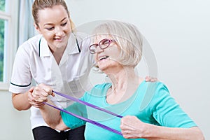 Senior Female Working With Physiotherapist