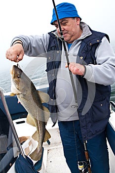 Senior fisherman with trophy