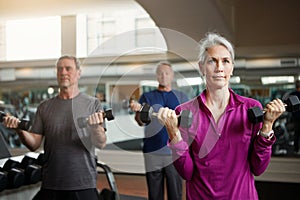 Senior fitness club, people and dumbbells at gym for training, health and wellness, sport or exercise. Class, workout