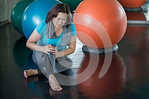 Senior fitness woman injury knee pain while exercising in gym. aged lady suffering from Arthritis . Old female workout .Mature