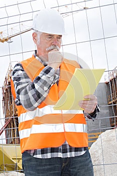 senior foreman looking at paperwork in site