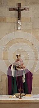 A Senior French Catholic priest is giving mass during a baptism in Aquitaine