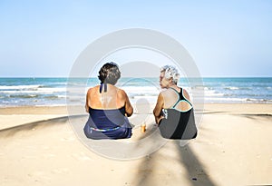 Senior friends chilling on the beach