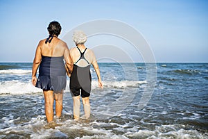 Senior friends chilling on the beach photo