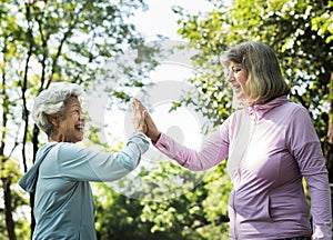 Senior friends exercising outdoors together