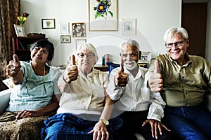 Senior friends gesturing thumbs up