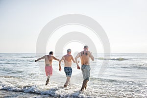 Senior friends having fun at the beach