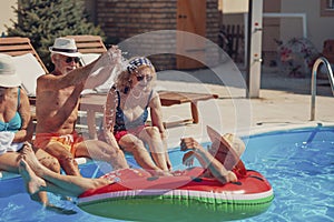 Senior friends having fun at the swimming pool