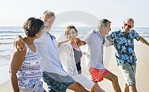 Senior friends playing at the beach