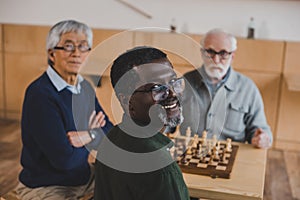 Senior friends playing chess